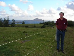 Max standing beside his ancestor's land on Norfolk Island